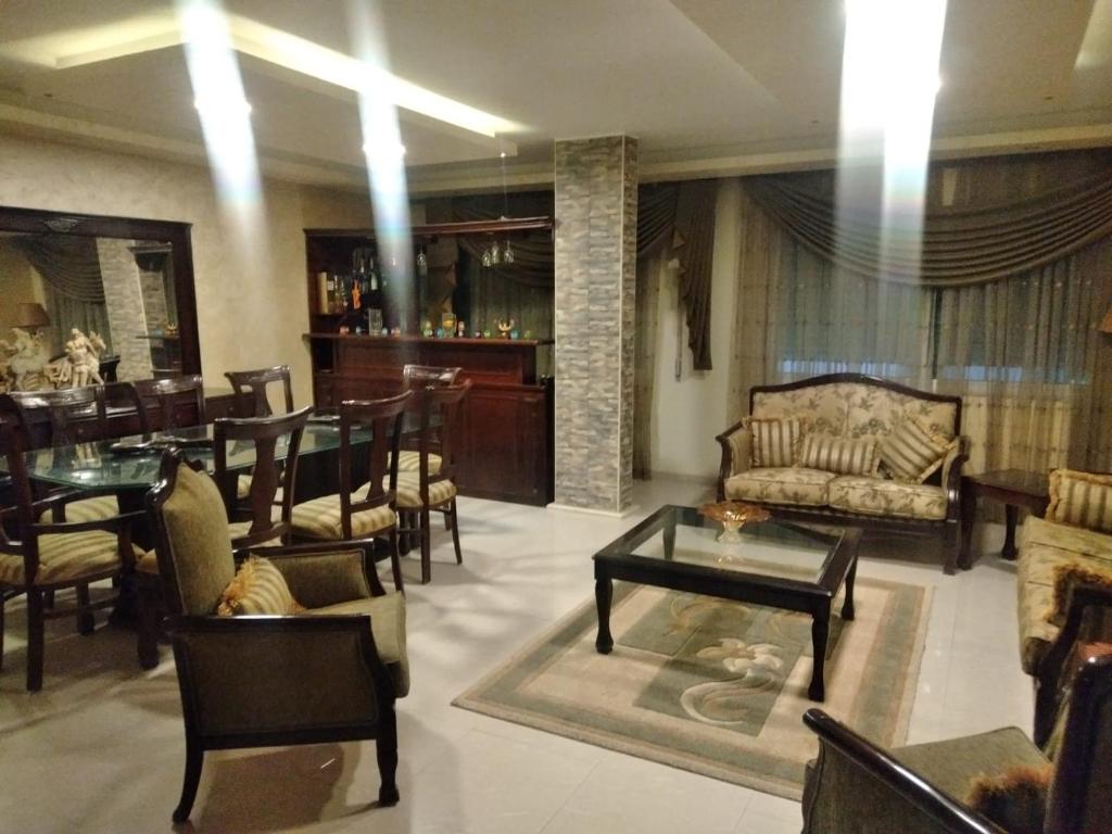 马达巴City Center Furnished Apartment的客厅配有沙发和桌椅
