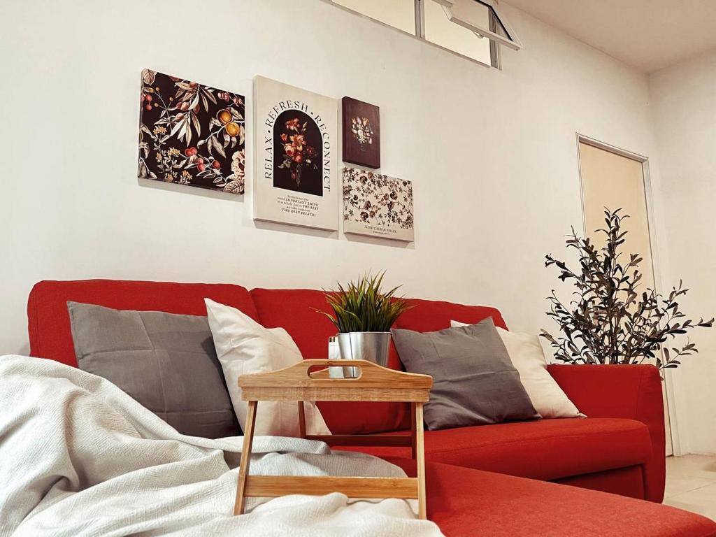 吉隆坡Arcoris Mont Kiara 1~6 Pax Contemporary Living Netflix的客厅配有红色的沙发和桌子