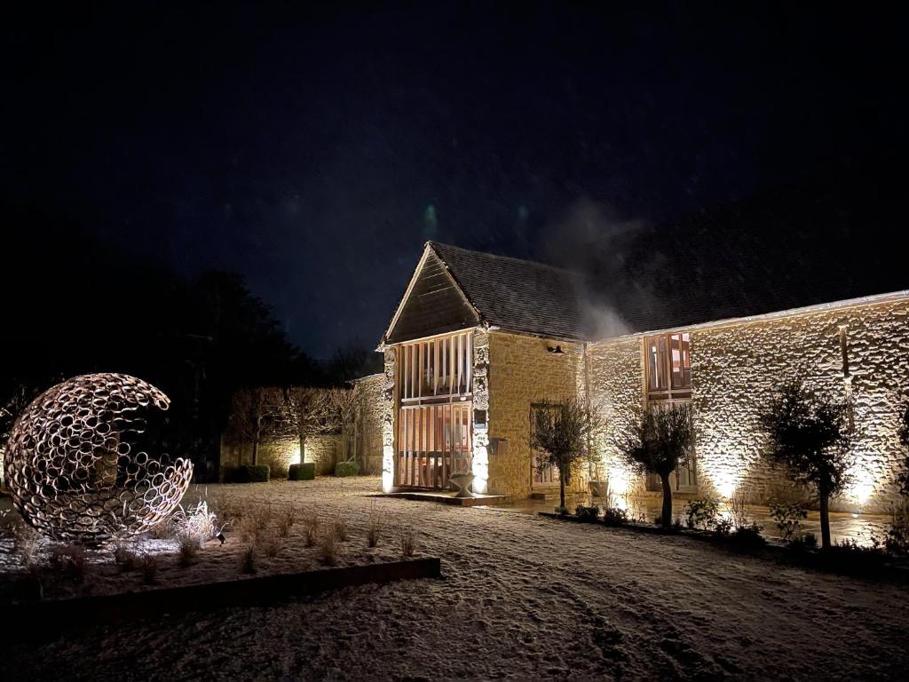 Great Milton17th Century Barn near Le Manoir aux Quat’Saisons的一座晚上有圣诞树的建筑