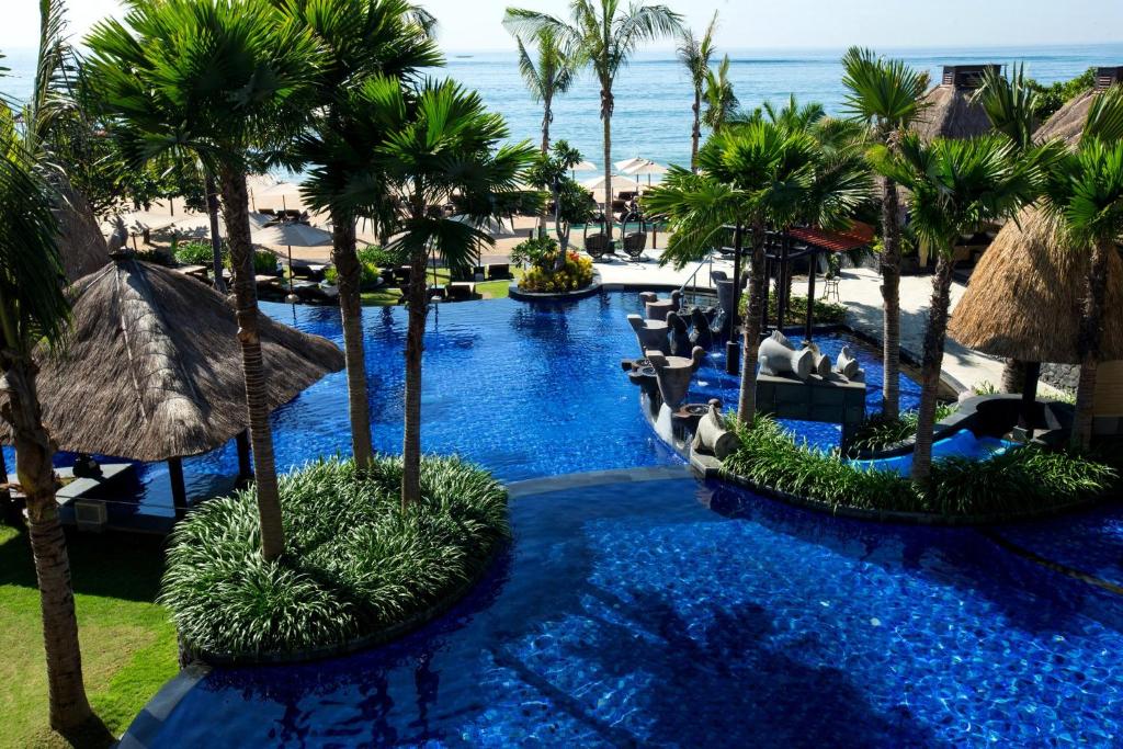 努沙杜瓦Holiday Inn Resort Bali Nusa Dua, an IHG Hotel - CHSE Certified的享有棕榈树度假村游泳池的空中景致