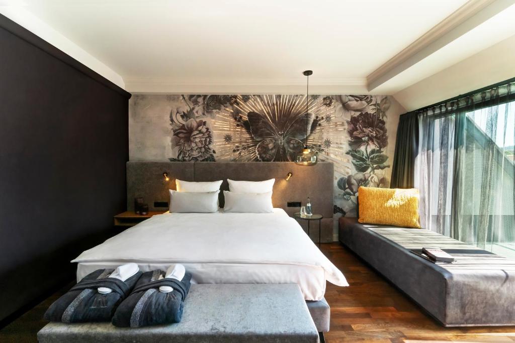 拉芬斯堡Hotel Kaiserhof Ravensburg的一间卧室设有一张大床和一个大窗户