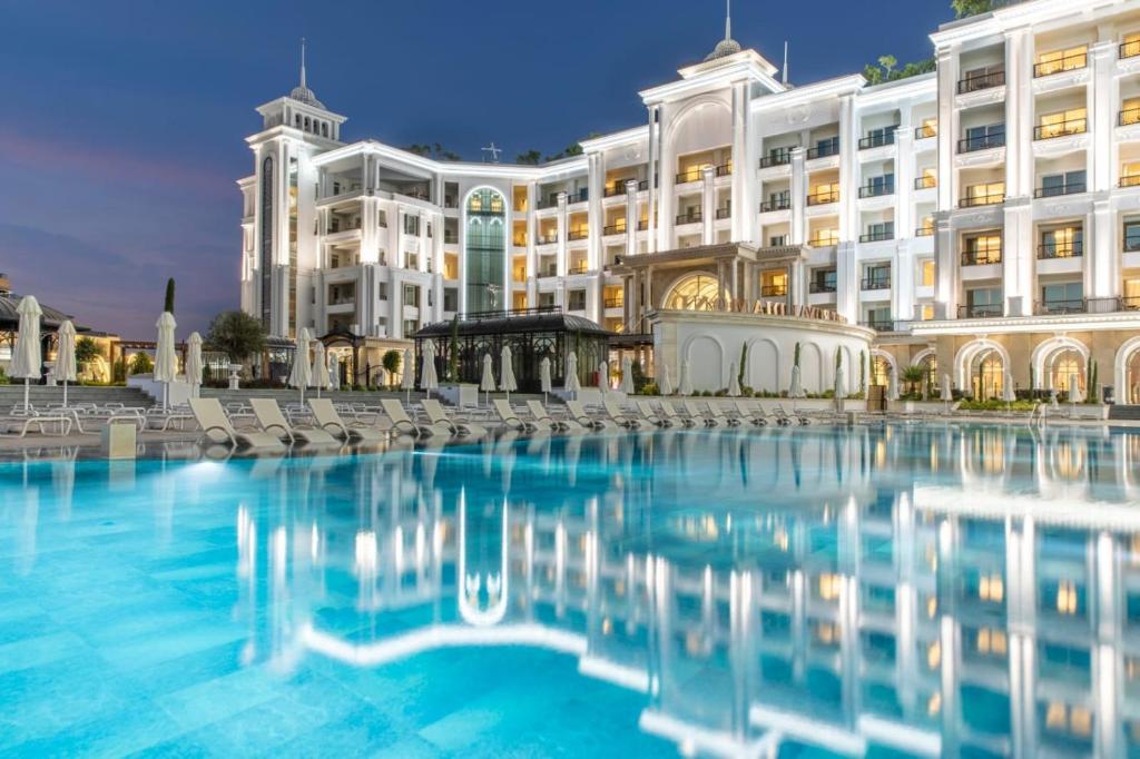 凯里尼亚Merit Royal Diamond Hotel & SPA的一座大型建筑,前面设有一个游泳池