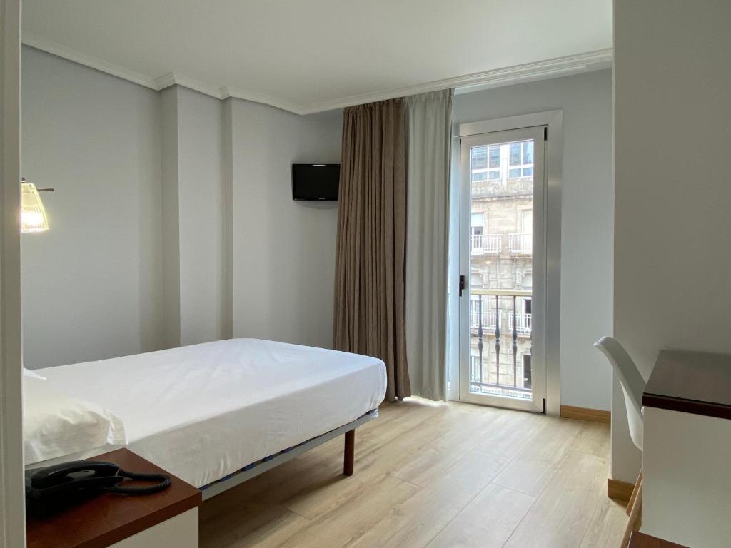 维戈Hotel Arsus的酒店客房设有床和窗户。