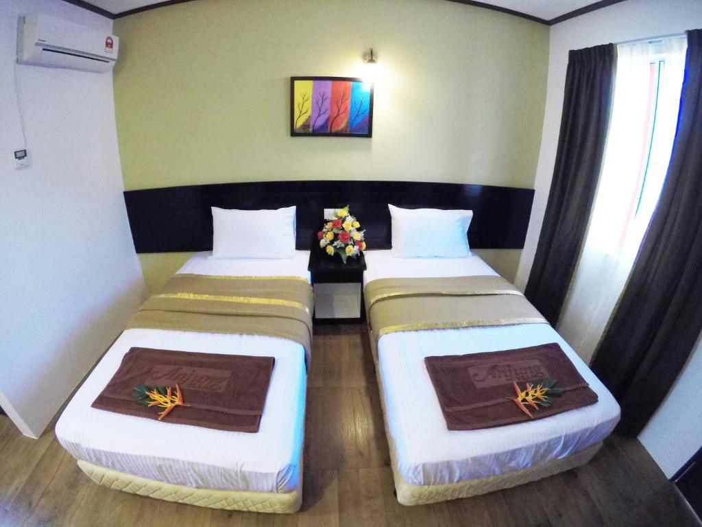 珍南海滩安贞别墅酒店的小型客房配有两张床,