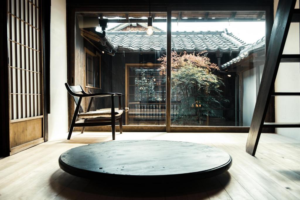Tamba-sasayamaOito 美しい街並みに佇む喫茶と宿的客房设有桌子、椅子和窗户。