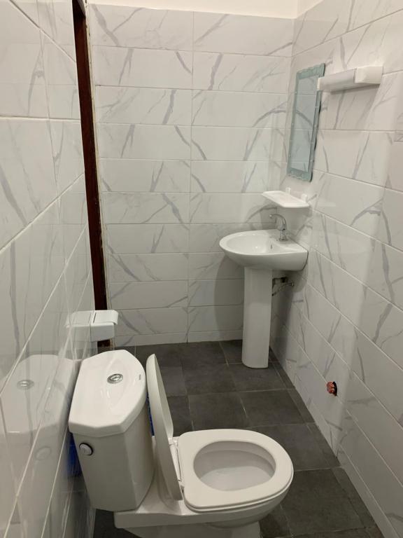 科托努Peaceful Stay 1SR的白色的浴室设有卫生间和水槽。