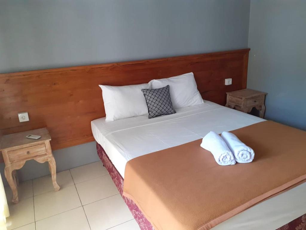 坎古庞多克迪迪克旅馆的一间卧室配有一张带两个枕头的床
