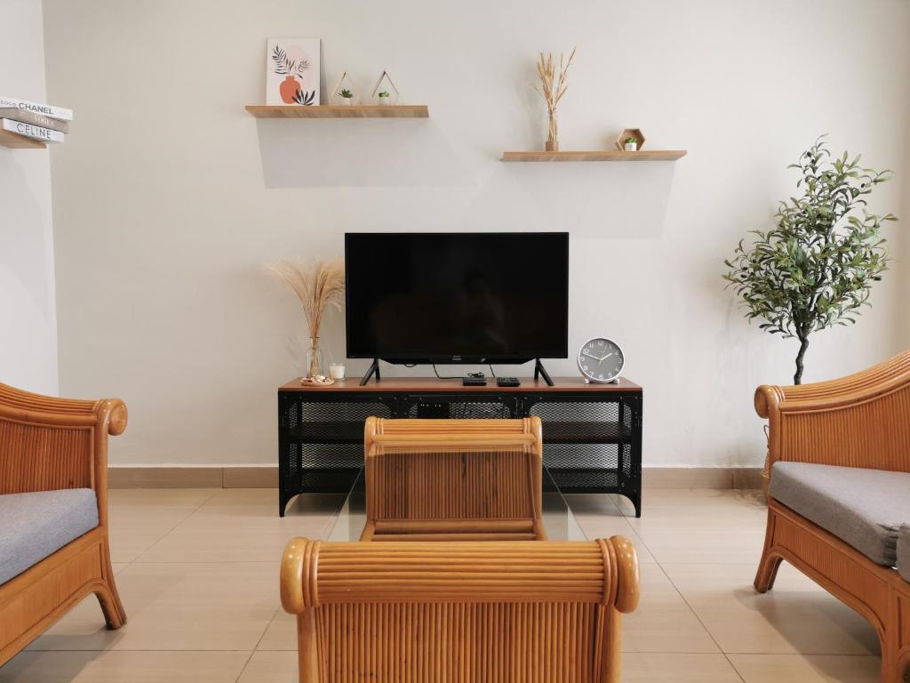 马六甲28 Residence Homestay的客厅配有电视和2把椅子