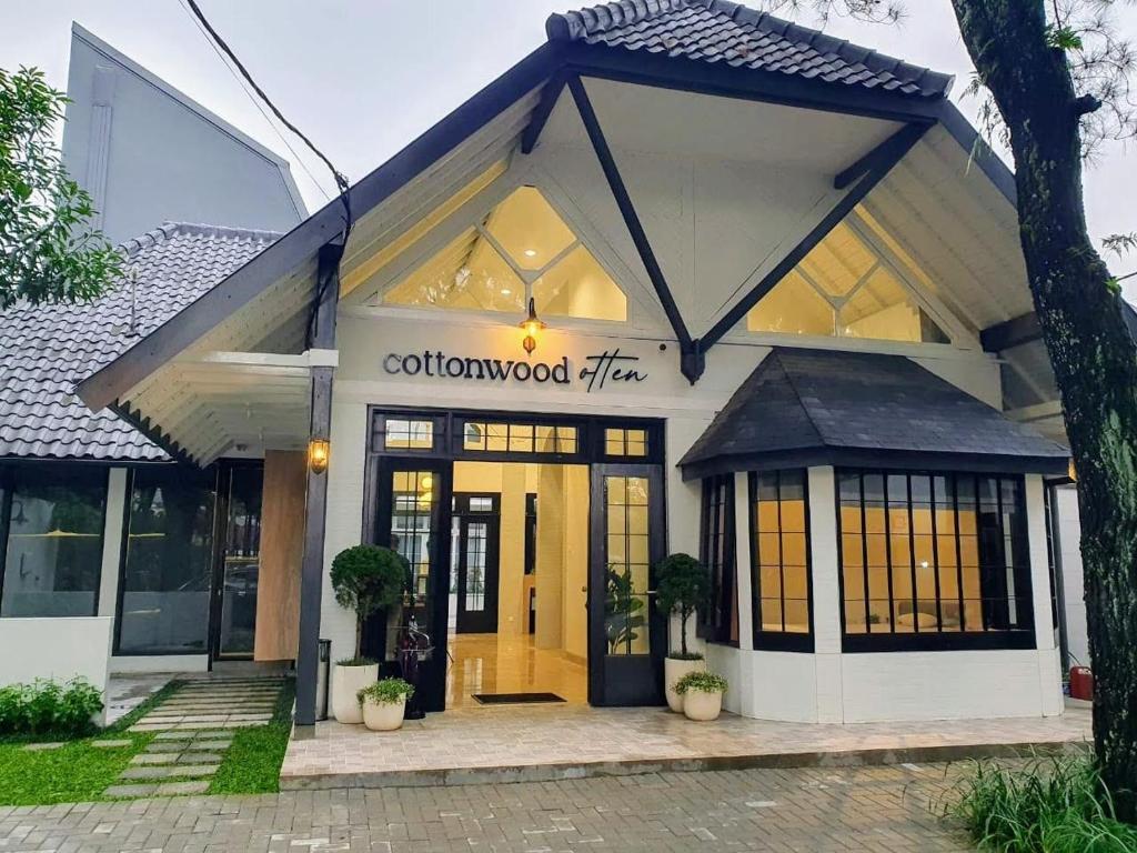 万隆Cottonwood Boutique Heritage Otten的建筑前面的商店,有黄色的门