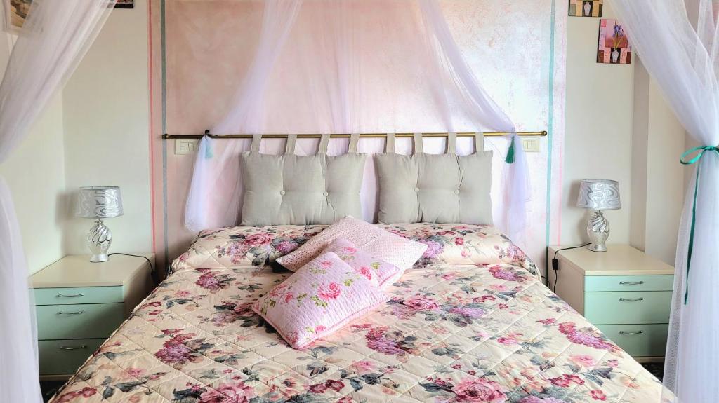 圣奎里科-多尔恰Camera La Margherita的一间卧室配有一张粉红色天蓬床