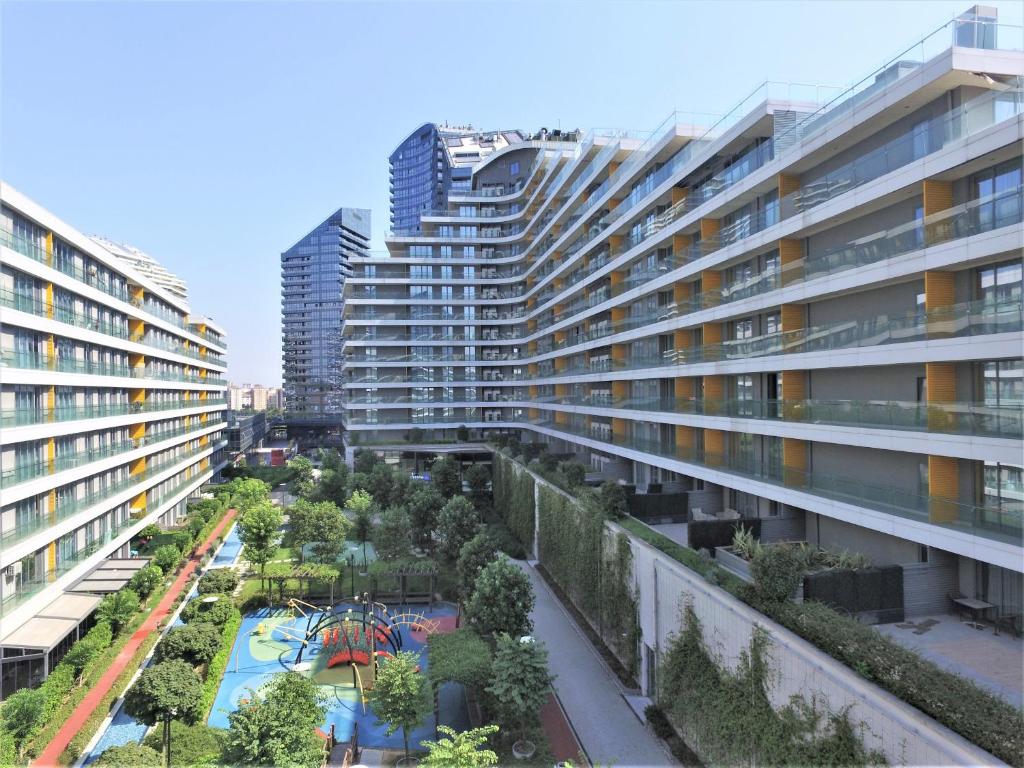 伊斯坦布尔The Superior Living Batışehir的公寓大楼设有花园和游乐场