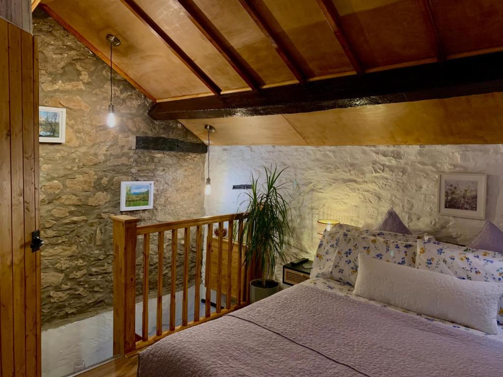 CoityOld Nursery的一间卧室设有一张床和石墙