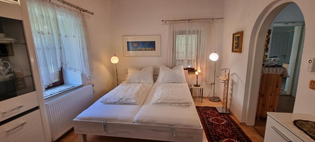 沃尔夫斯堡Innenstadtgarten-Wohnung的一间卧室设有两张床和两个窗户。