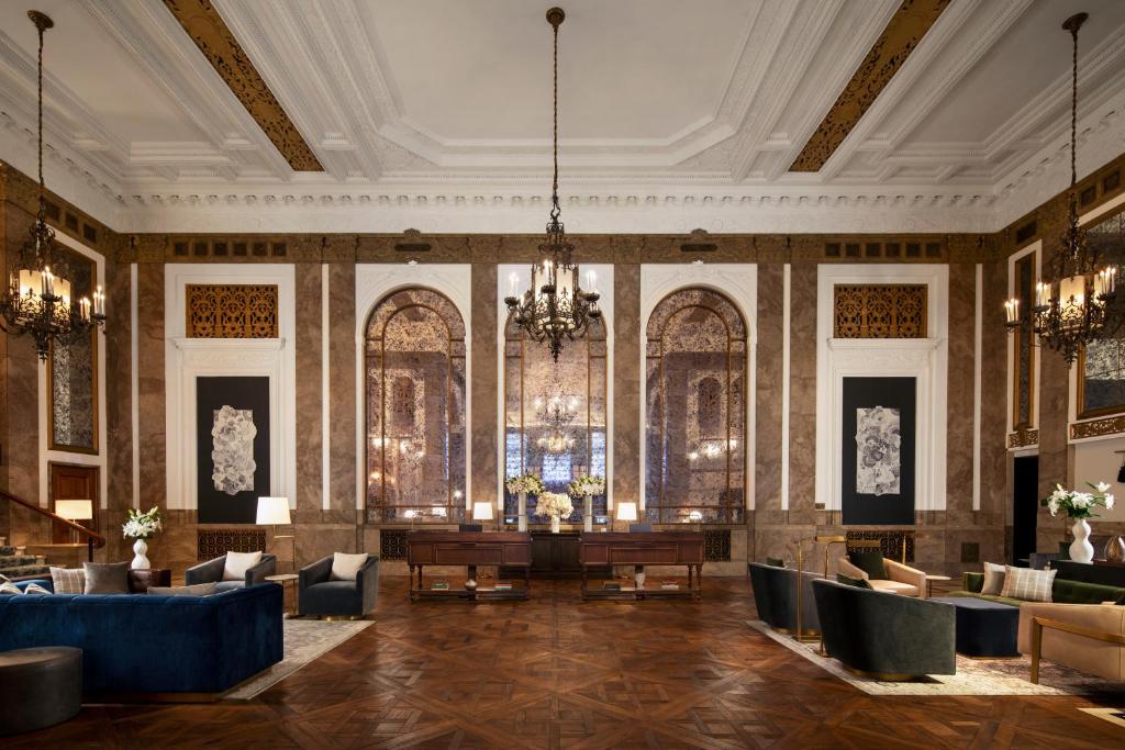 旧金山Beacon Grand, A Union Square Hotel的大堂配有桌椅和吊灯。