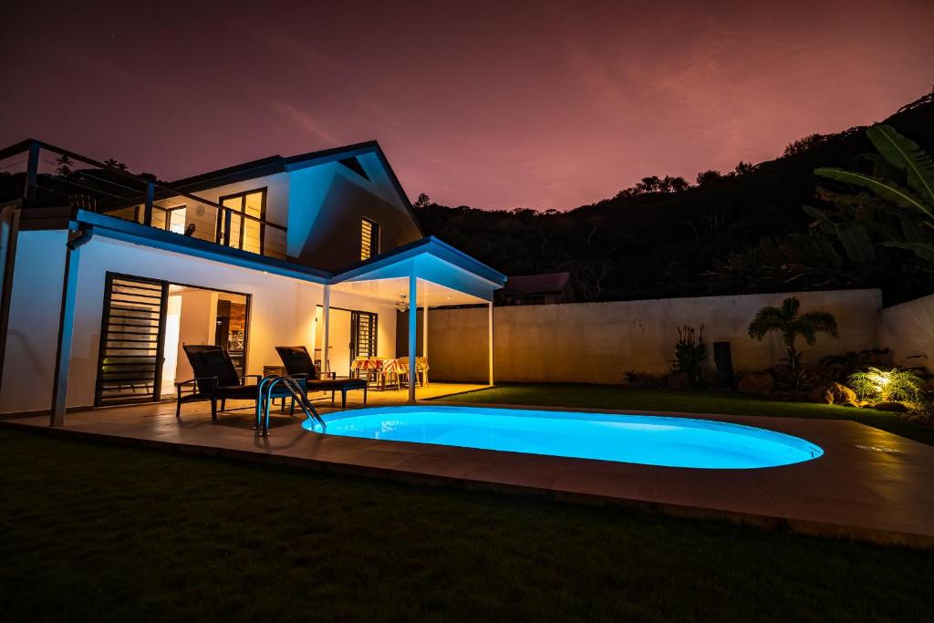 波拉波拉Hidden Villas by Matira Beach的夜间带游泳池的别墅