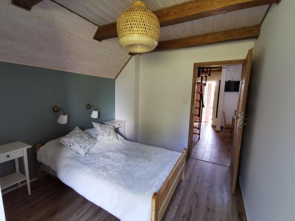 波拉齐克Apartament Jaśmin的卧室配有白色的床,铺有木地板