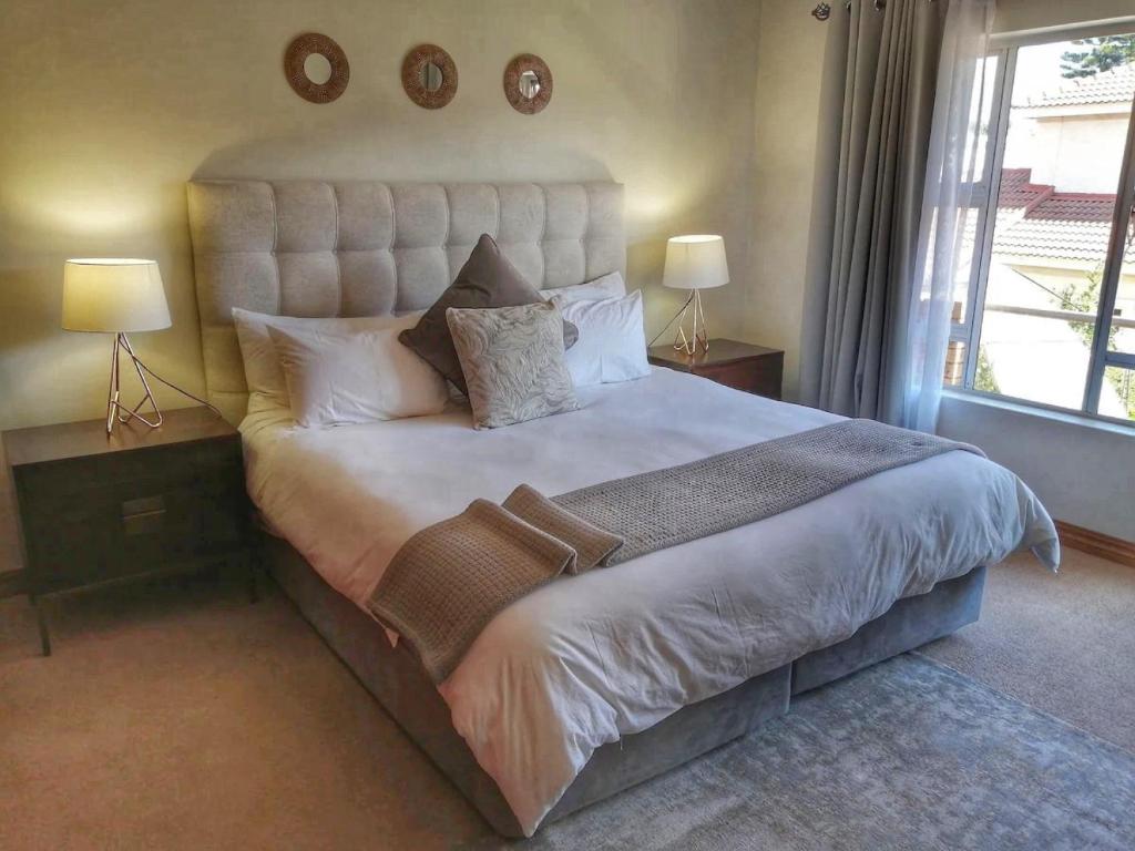 逊邱伦The Monte Carlo的一间卧室配有一张带两盏灯的大型白色床。