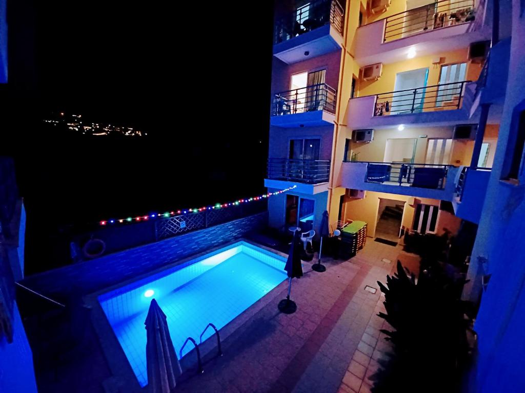 赫索尼索斯Olympic Star的一座游泳池,在晚上在建筑物前