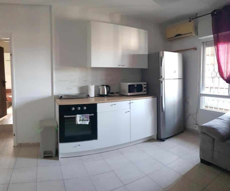 LodCozy Flat with Parking well-placed near TLV Airport的厨房配有炉灶和冰箱。