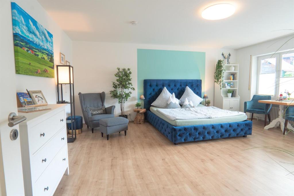 沙伊代格Ferienwohnung BergPfote的一间卧室配有蓝色的床和椅子