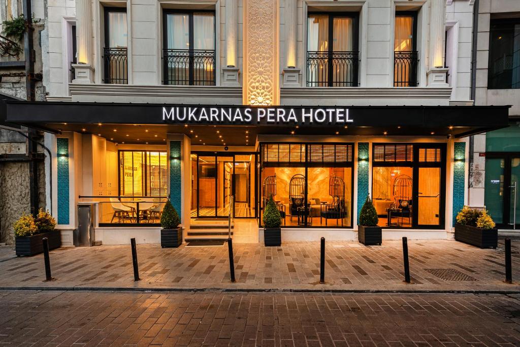 伊斯坦布尔Mukarnas Pera Hotel的标有读过莫汉斯佩拉酒店标志的酒店