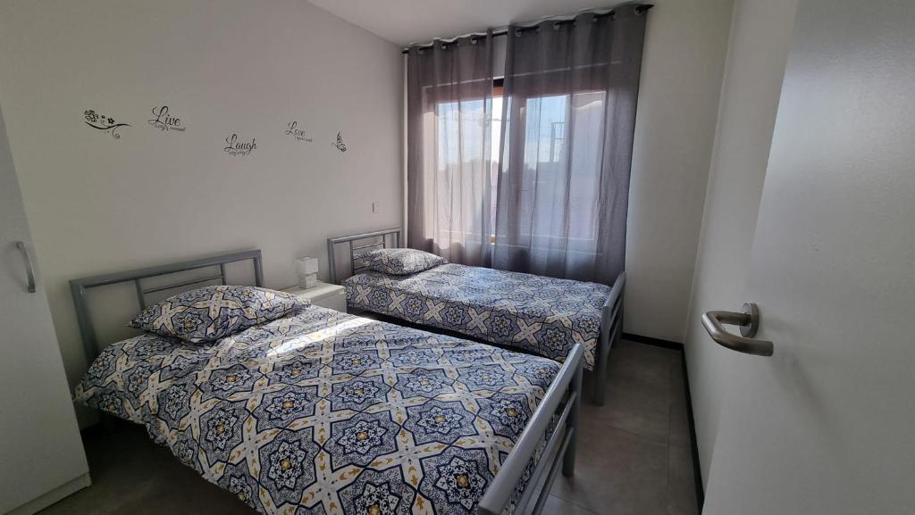 鲁瑟拉勒Rossella B&B App 4的小型客房 - 带2张床和窗户