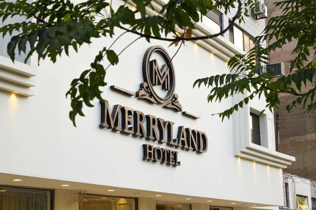安曼New MerryLand Hotel的麦金兰房子的一侧的标志