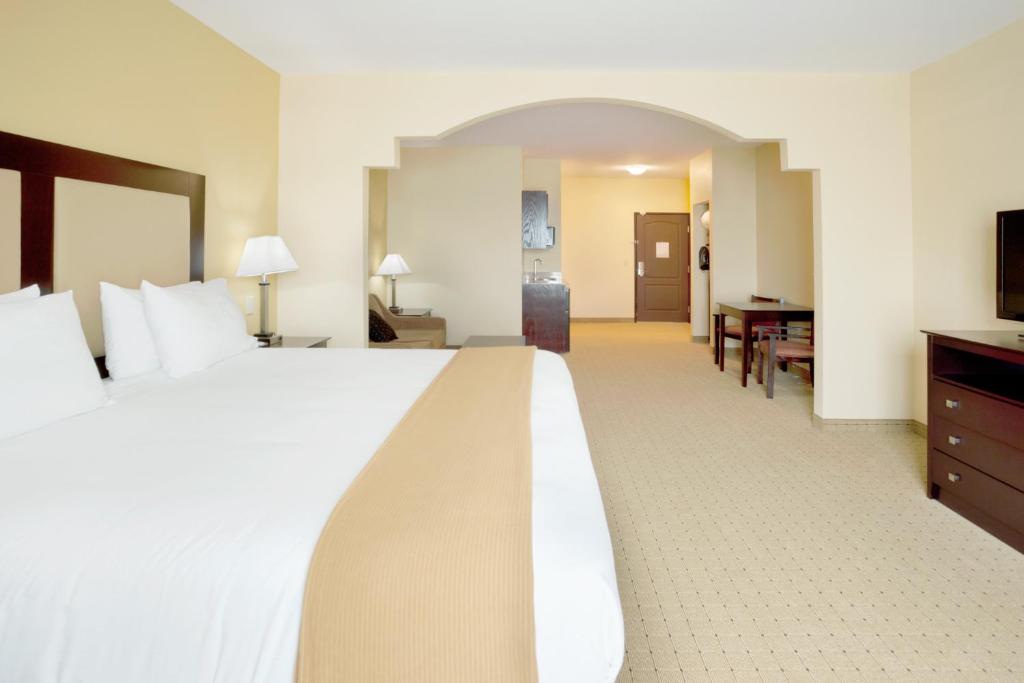 乔治城乔治敦快捷假日酒店的酒店客房设有一张大床和一张书桌。