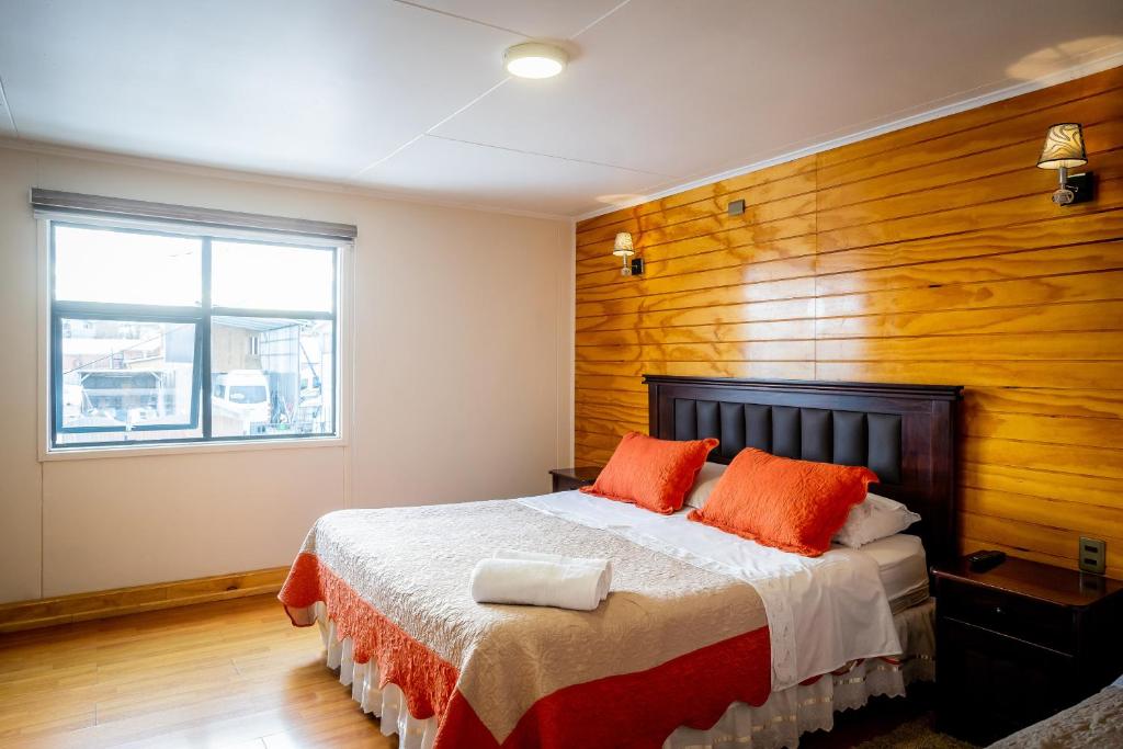 纳塔列斯港露西住宿加早餐旅馆的一间卧室配有一张木墙床
