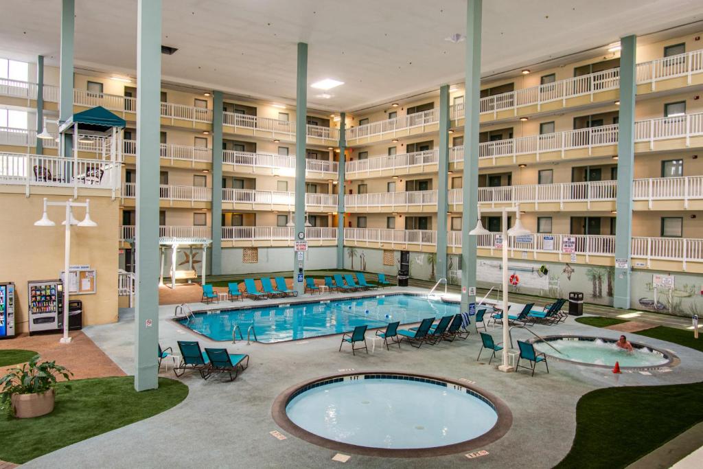 希尔顿黑德岛Beach side condo at Hilton Head Resort Villas的一座大型酒店,在一座建筑前设有一个游泳池