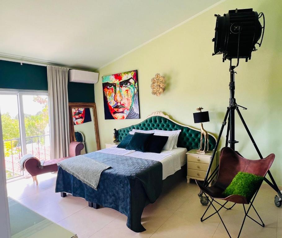 卢斯Palm View Guesthouse, adults only的卧室配有床和三脚架上的摄像头