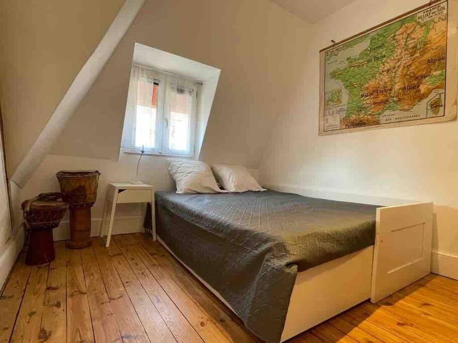 维希Maison de caractère en centre ville的卧室配有一张床,墙上有地图