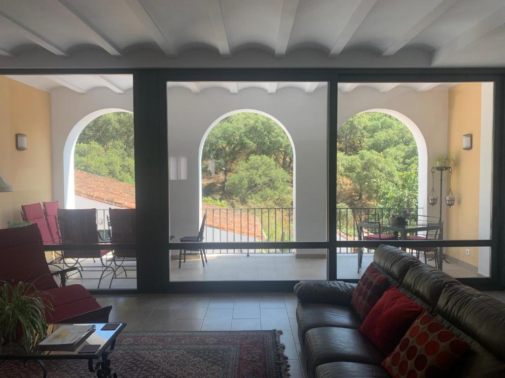 阿拉哈尔Casa Carmen的客厅设有2扇拱形窗户和1张沙发
