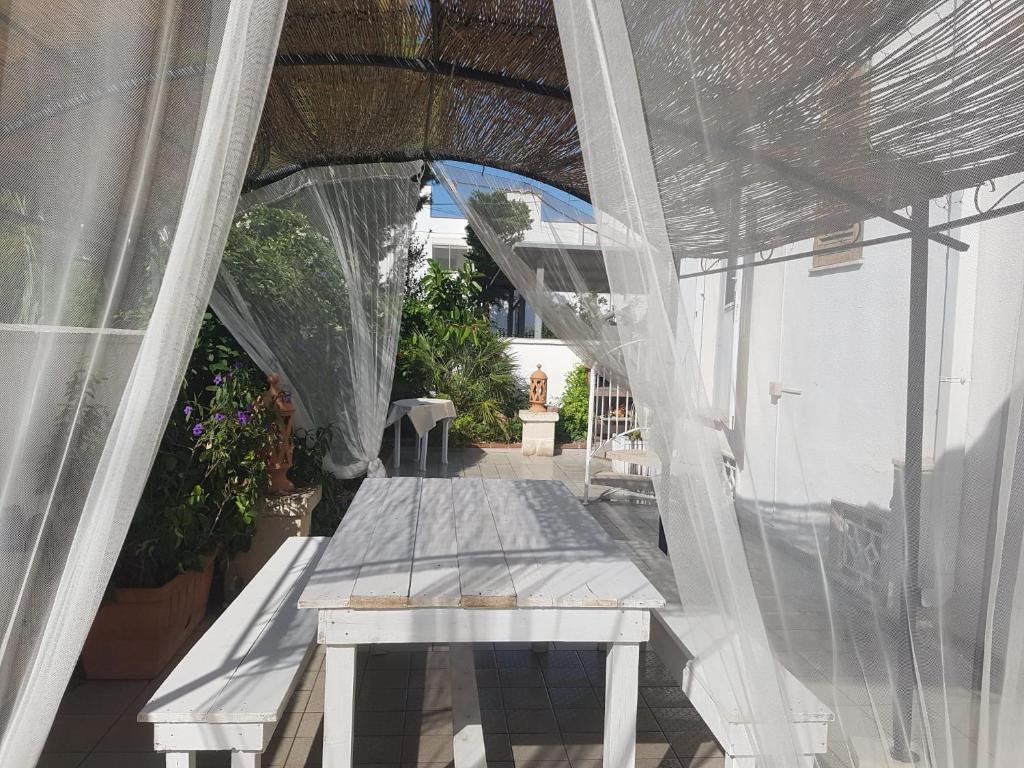 贝瓦尼亚圣彼得Villa San Michele的户外庭院设有桌子和透明的天篷