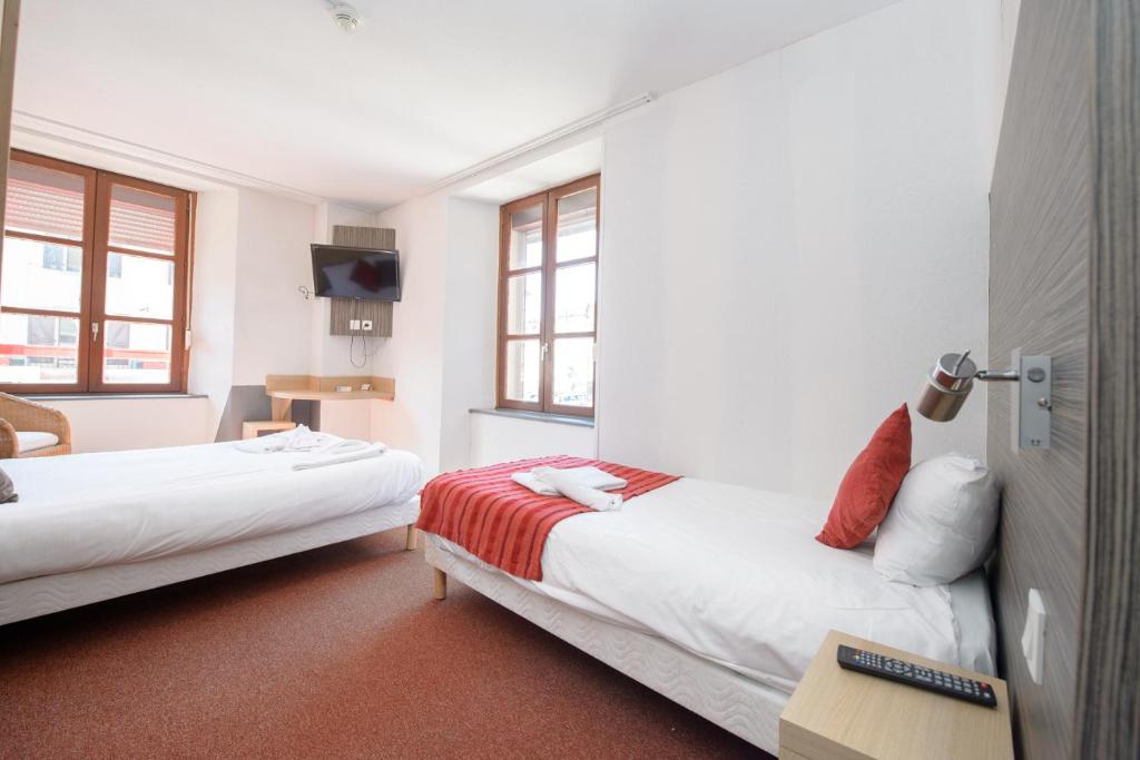 Pont-de-RoideHOTEL DES VOYAGEURS的酒店客房设有两张床和电视。