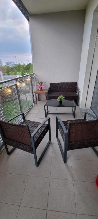 米兰La maison de Florina的阳台设有2张长椅和1张桌子。