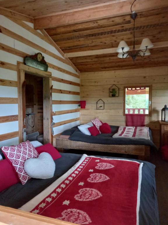 MontmorotChalet cocooning pleine nature的小木屋内一间卧室,配有两张床