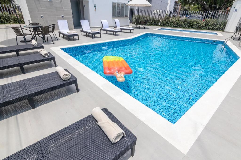 内瓦GHL内瓦酒店的一个带椅子的游泳池以及一个充气泳池玩具