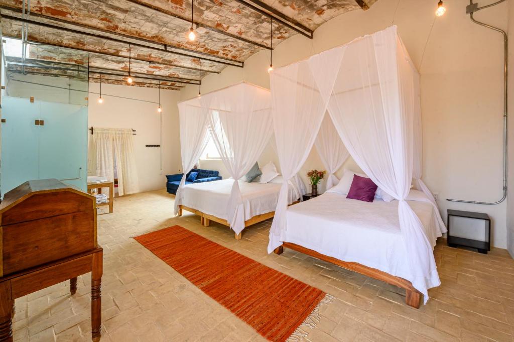 瓦哈卡市Ex Hacienda San José的一间卧室配有两张床和蚊帐