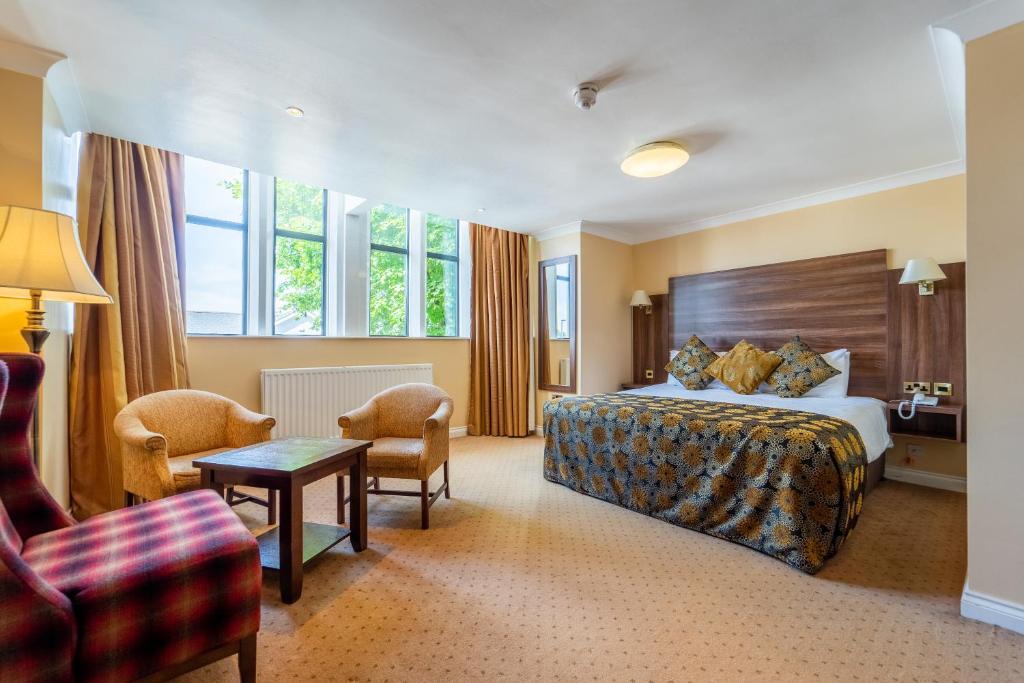 巴利米纳阿代尔阿尔姆斯酒店的酒店客房带一张床、一张桌子和椅子