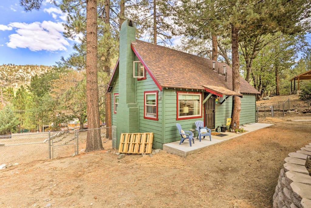 赖特伍德Wrightwood Cabin with Cozy Interior!的前面有两把椅子的小绿色房子