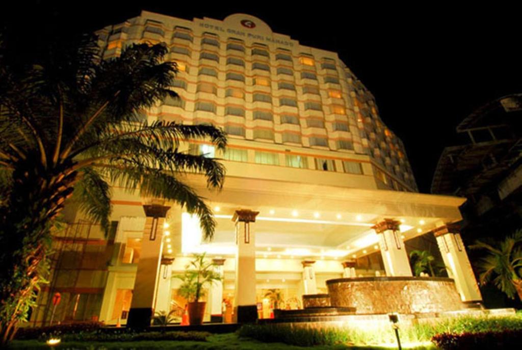 美娜多格兰普里美娜多酒店的一座大建筑,前面有棕榈树