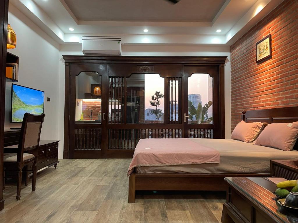 河内Eco nest的一间卧室配有一张床、一张书桌和一个窗户。