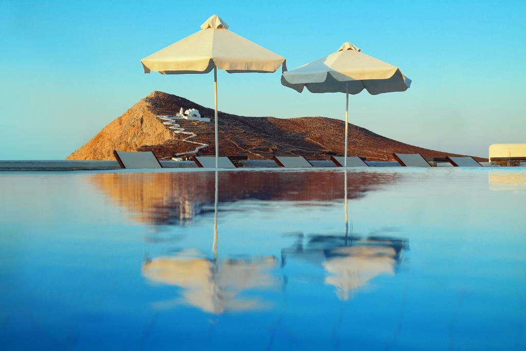 乔拉弗雷恩多斯米拉马雷酒店的两把遮阳伞和椅子坐在水里
