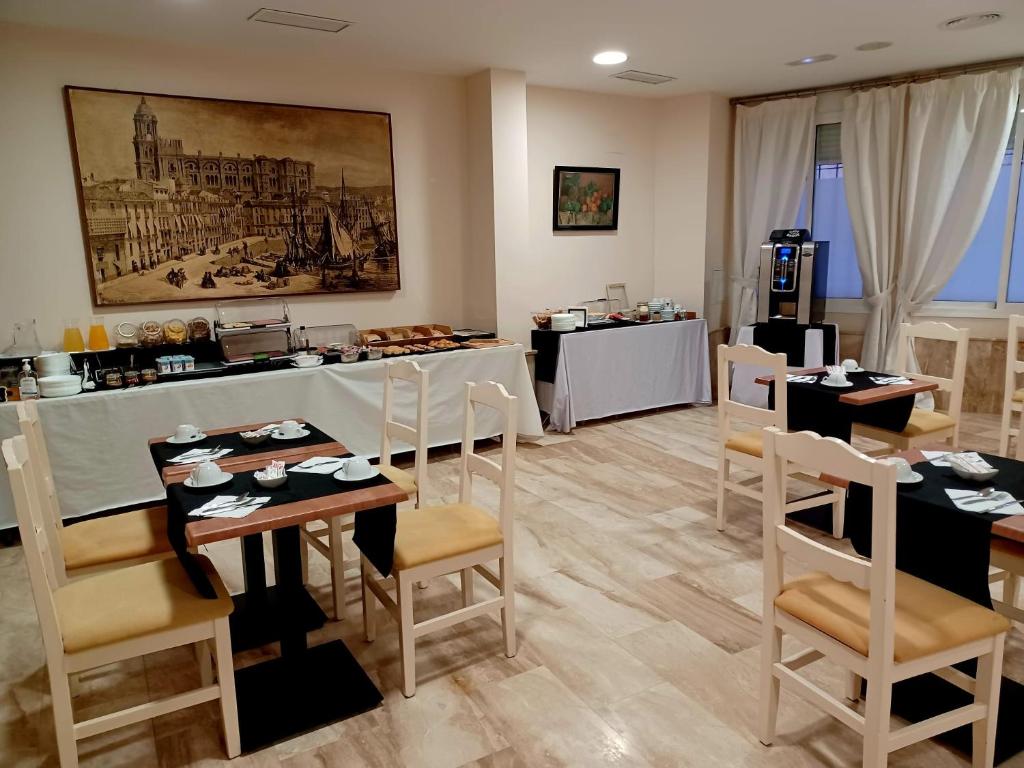 马拉加马拉加卡洛斯五世酒店的一间带桌椅和柜台的餐厅