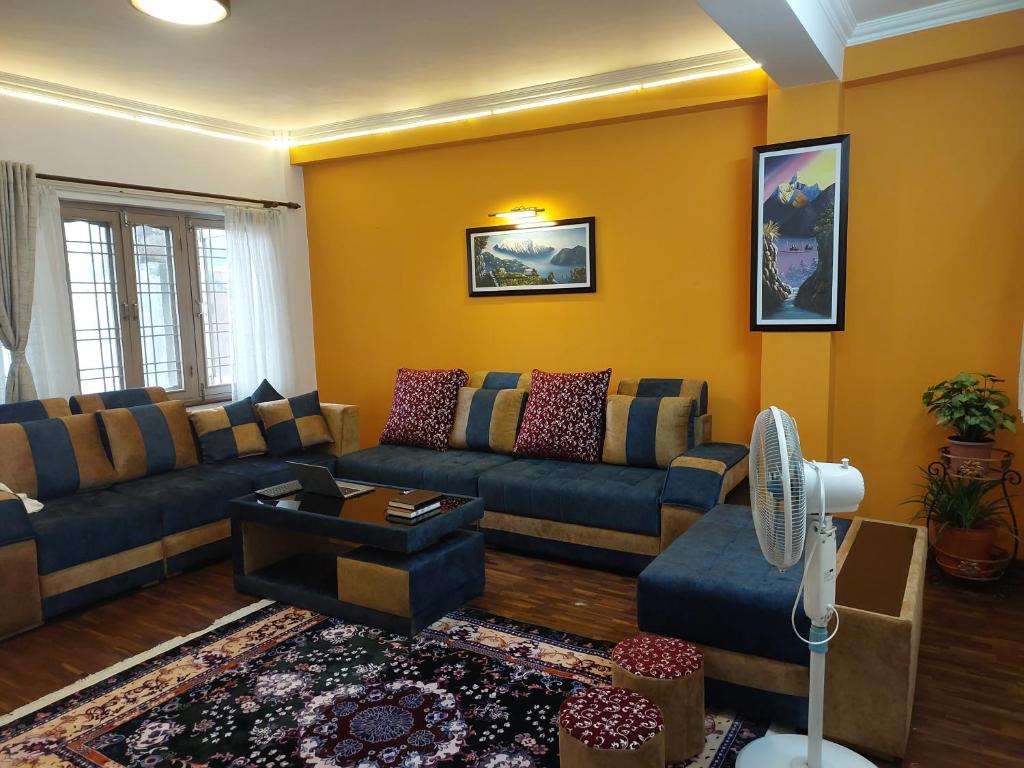 帕坦Nepal christian guest house的客厅配有沙发和桌子