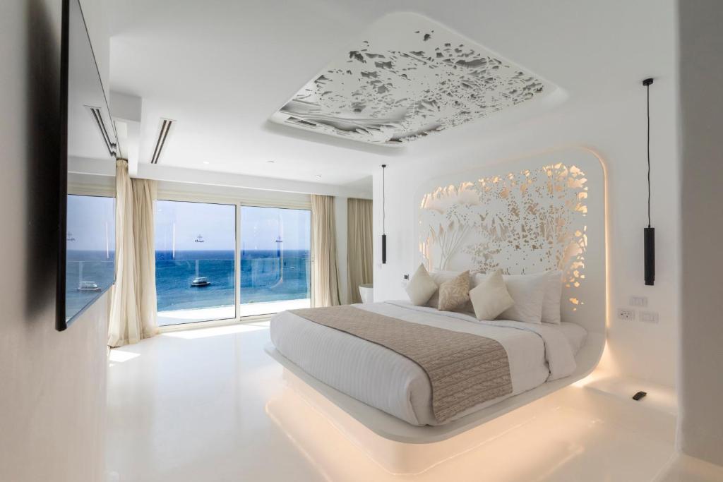 沙姆沙伊赫Meraki Resort Sharm El Sheikh Adults only的白色的卧室设有一张大床和一个大窗户