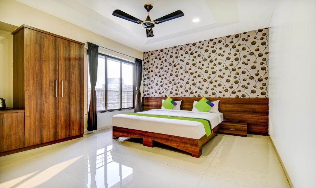 KharadiTreebo Trend Kuber Inn的一间卧室设有一张床和一个窗口