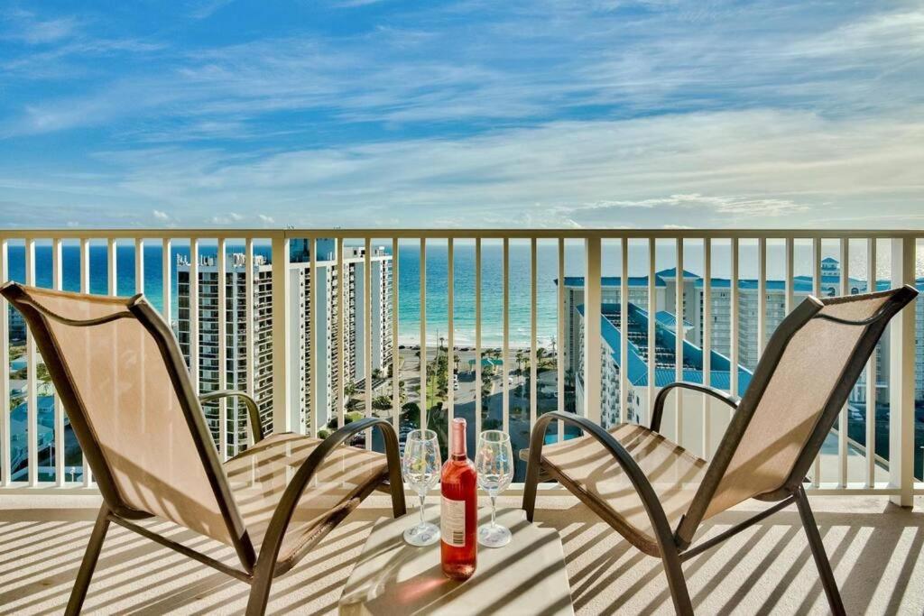 德斯坦Beautiful beach home for a perfect vacation的阳台配有两把椅子和一瓶葡萄酒