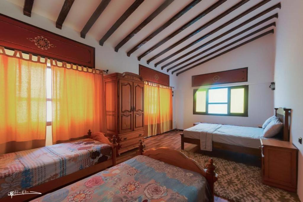 舍夫沙万Casa Plasa Grande CHAOUEN的大房间设有两张床和窗户